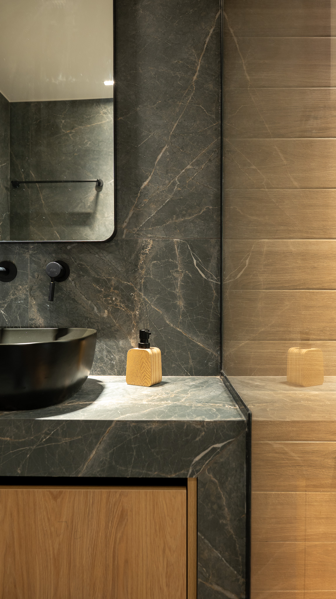 A&K Chorothetisis, bath detail with black tap and soap dispenser on grey marble counter