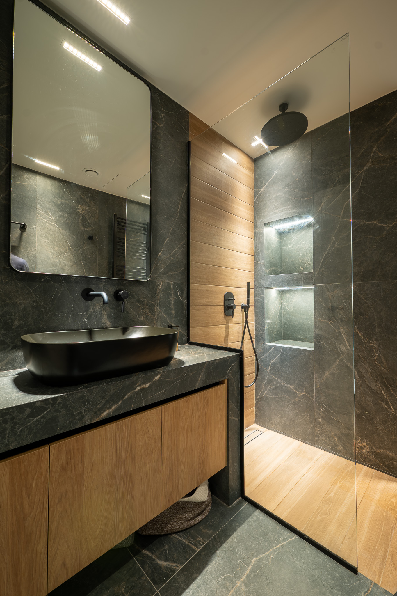 A&K Chorothetisis, guest bath vanity with black vessel sink, oak shower wall and grey marble