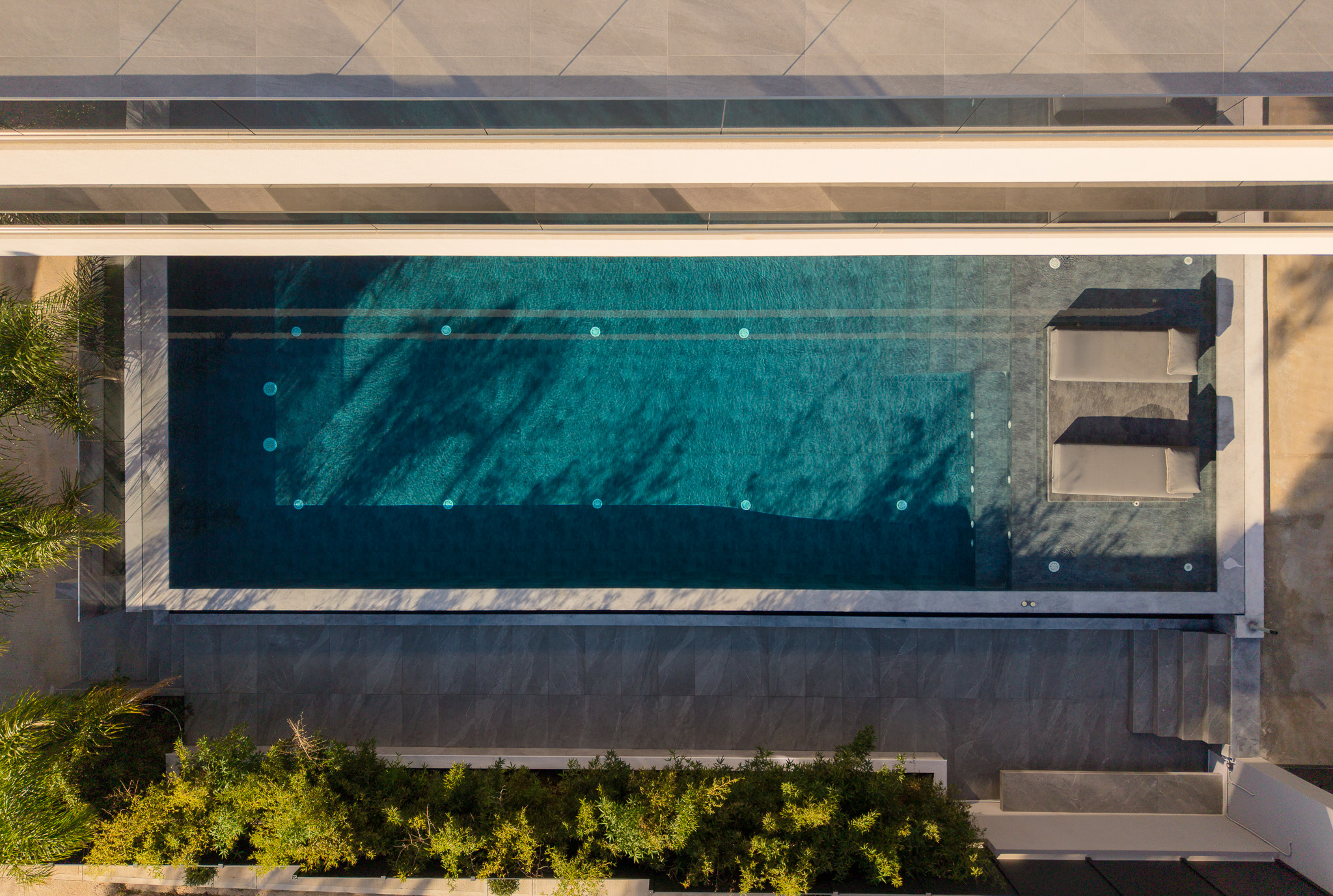 Villa Bond, top-down architectural pool with hanging chairs