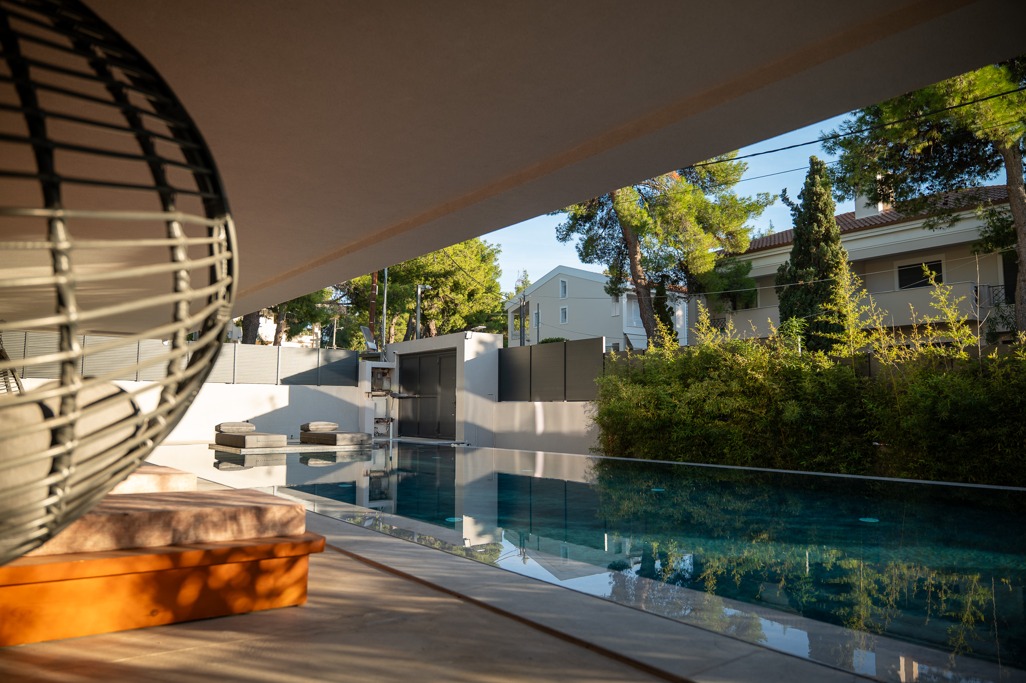 Villa Bond, pool view from under cantilever with hanging chair