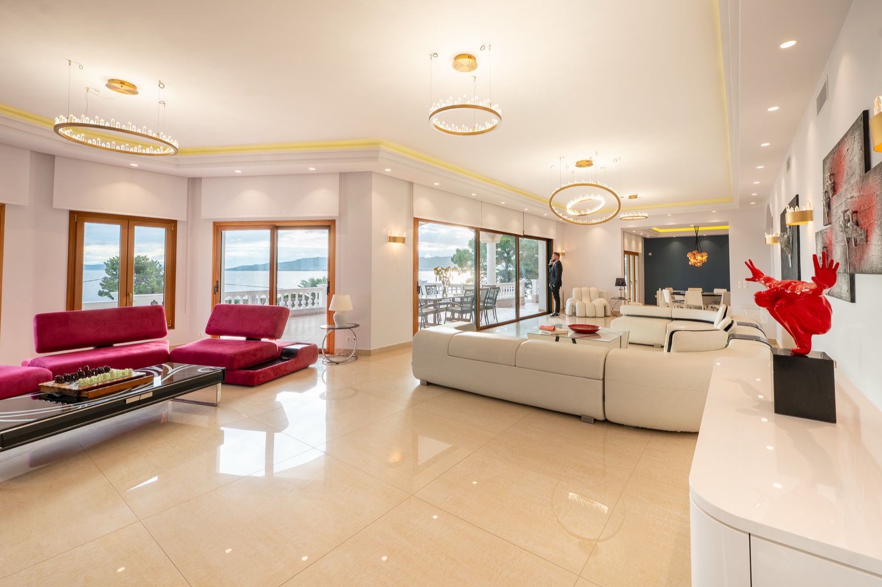 Villa Rafaella, bright living room with magenta accents and sea view